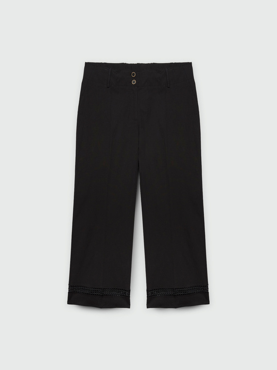 Cropped trousers with embroidery at the bottom