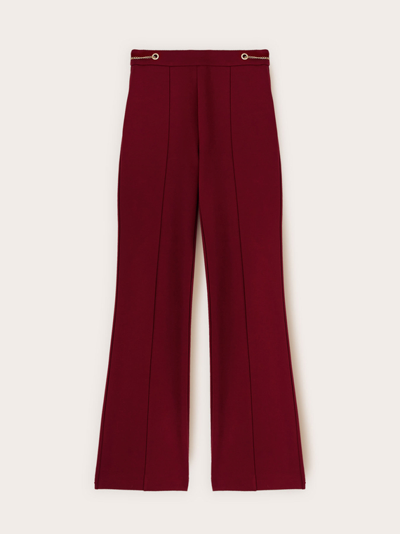 Flared trousers with eyelet pattern