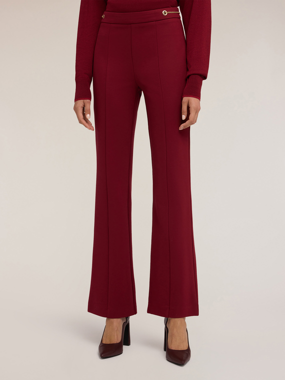 Flared trousers with eyelet pattern