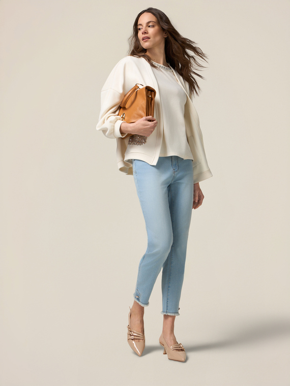 Skinny jeans with stone bleached effect and button details