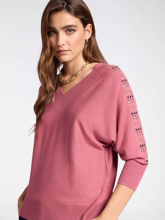 Sweater with studs on the sleeves