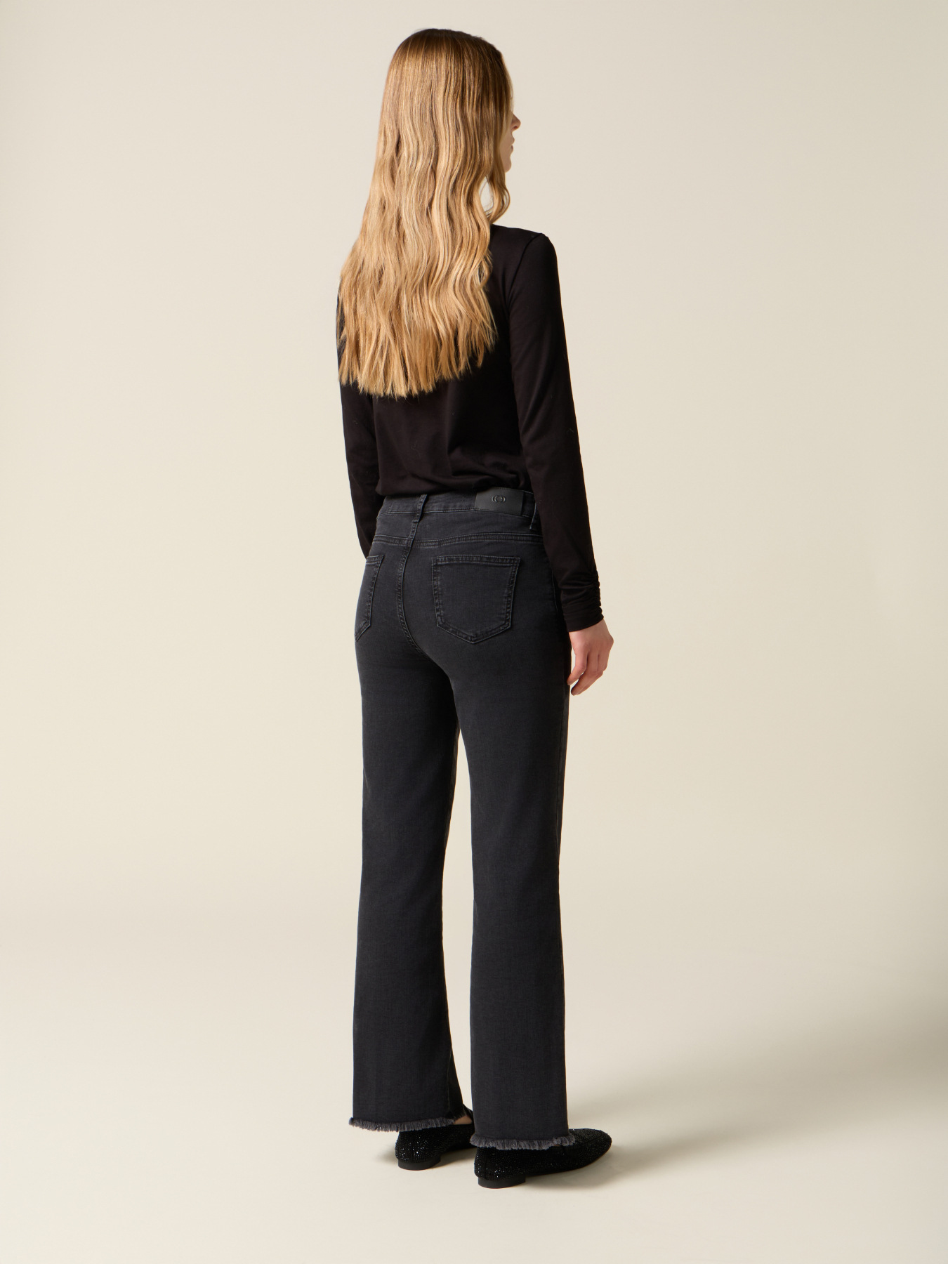 Black flare jeans with frayed hem image number 1