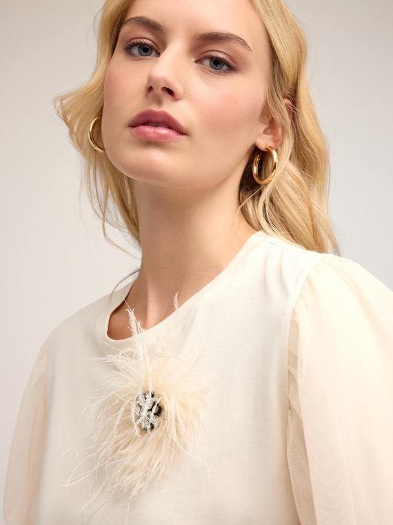 T-shirt with jewelled brooch and feathers